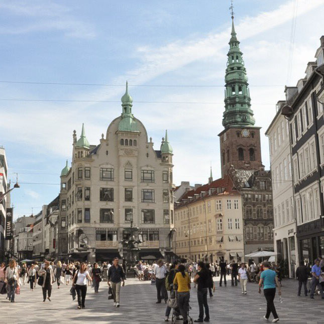 A busy, day on the central square of Strøget, with people walking in all directions.